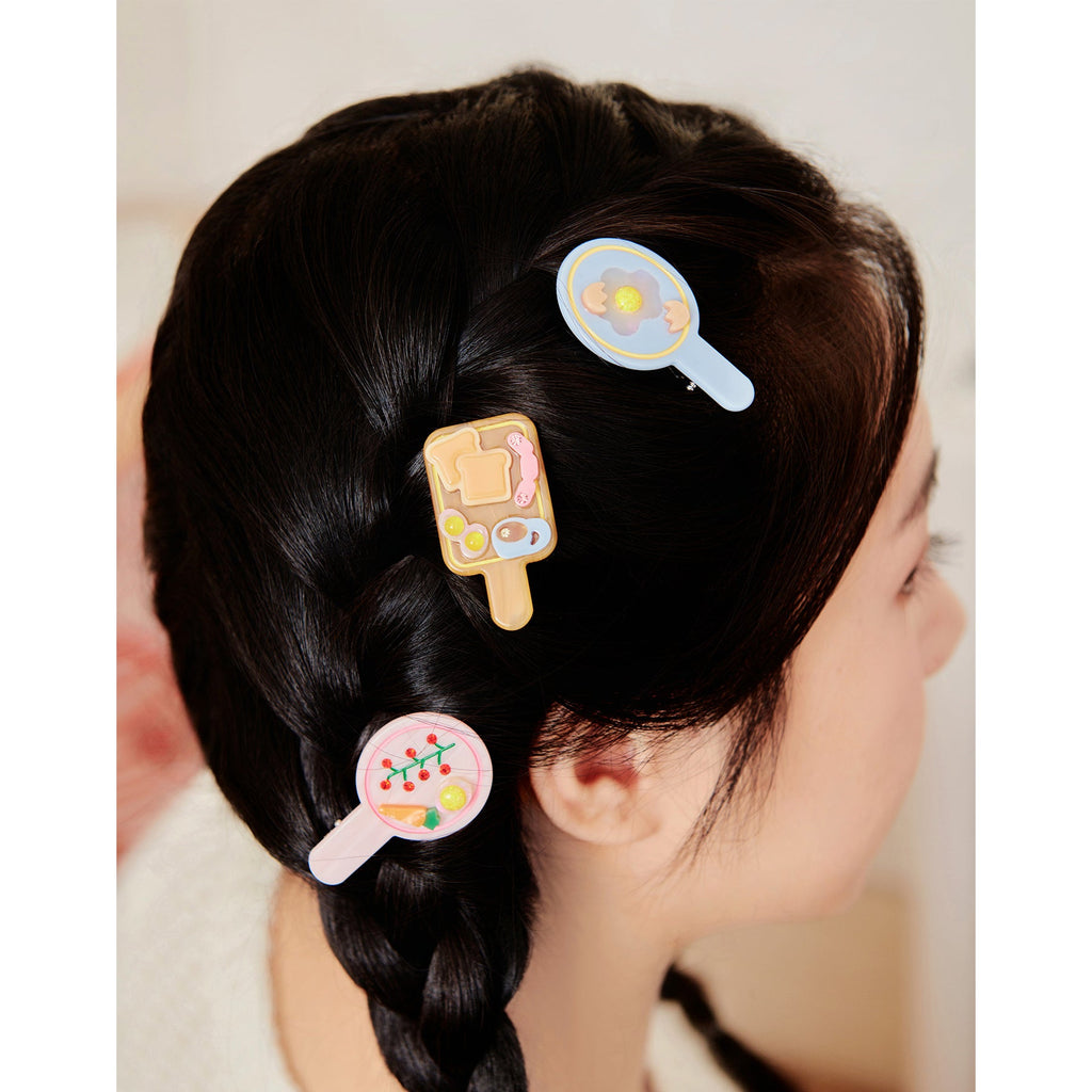 Likio breakfast hair clips worn in a braid