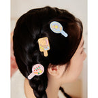 Likio breakfast hair clips worn in a braid