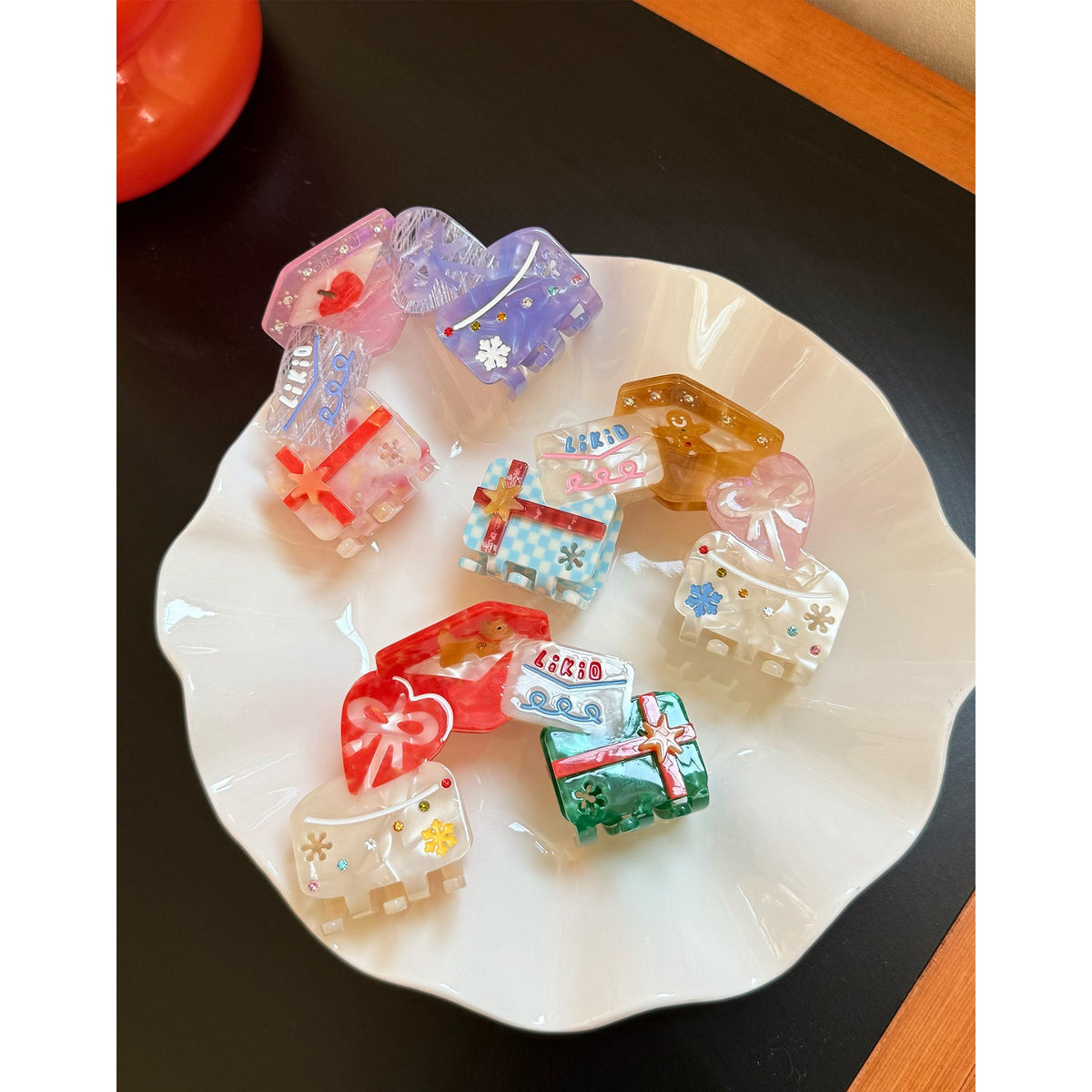 Likio Whimsical Holiday mini hair claws on a white dish