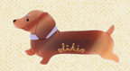 Likio Caramel Dog hair clip shaped like a caramel brown dachshund with gold logo